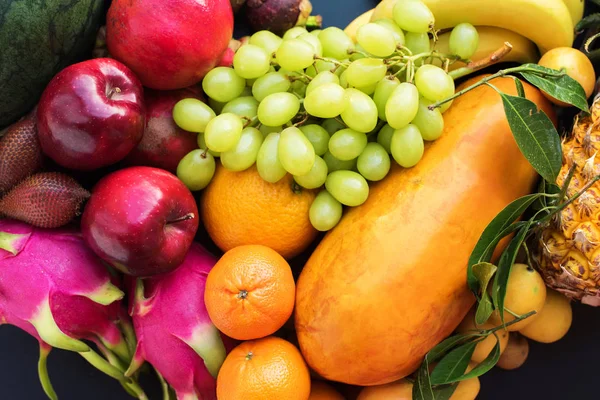 Set fresh organic exotic tropical fruit on dark — Stock Photo, Image