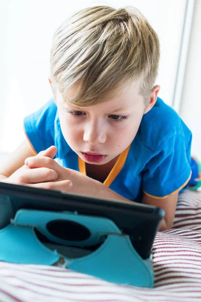 Closeup portrait of fairhair kid watching tablet — Stock Photo, Image