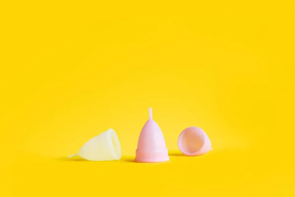 White pink reusable menstrual cup yellow color — Stock Photo, Image