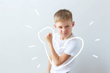 Child shows his force in the bent hand. Muscles clipart