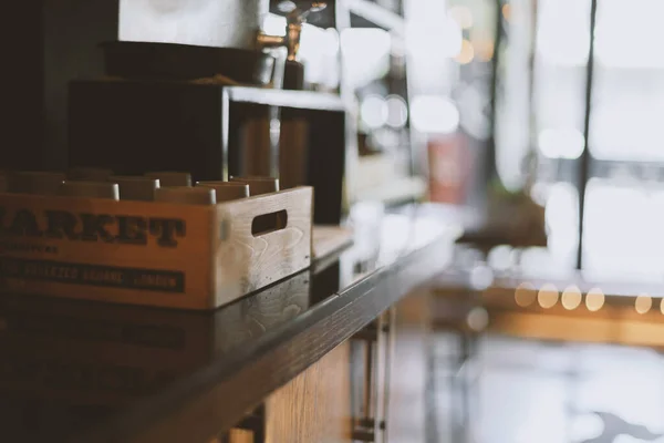 Wooden box with cups. Detail of interior of cafe and restaurant. Empty. Copy space. Defocused background. Equipment. Self service place