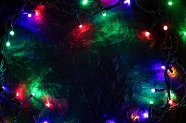 Noel ışıkları ve serbest metin alanı arka plan. Noel ışıkları sınır. Siyah arka plan üzerinde renkli Noel ışıkları parlayan. Yeni yıl. Noel. Dekor.