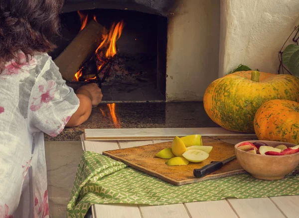 Woman Kindles Fire Oven Next Table Pumpkins Apples Vintage — Stock Photo, Image