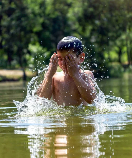 boy of seven years old is swimming in a lake
