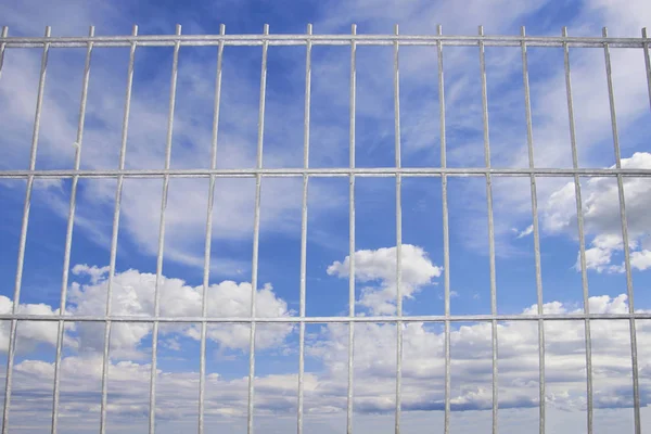 blue sky behind a wire lattice
