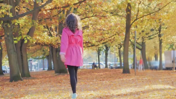 Feliz hermosa mujer caucásica caminando en el parque de otoño — Vídeo de stock