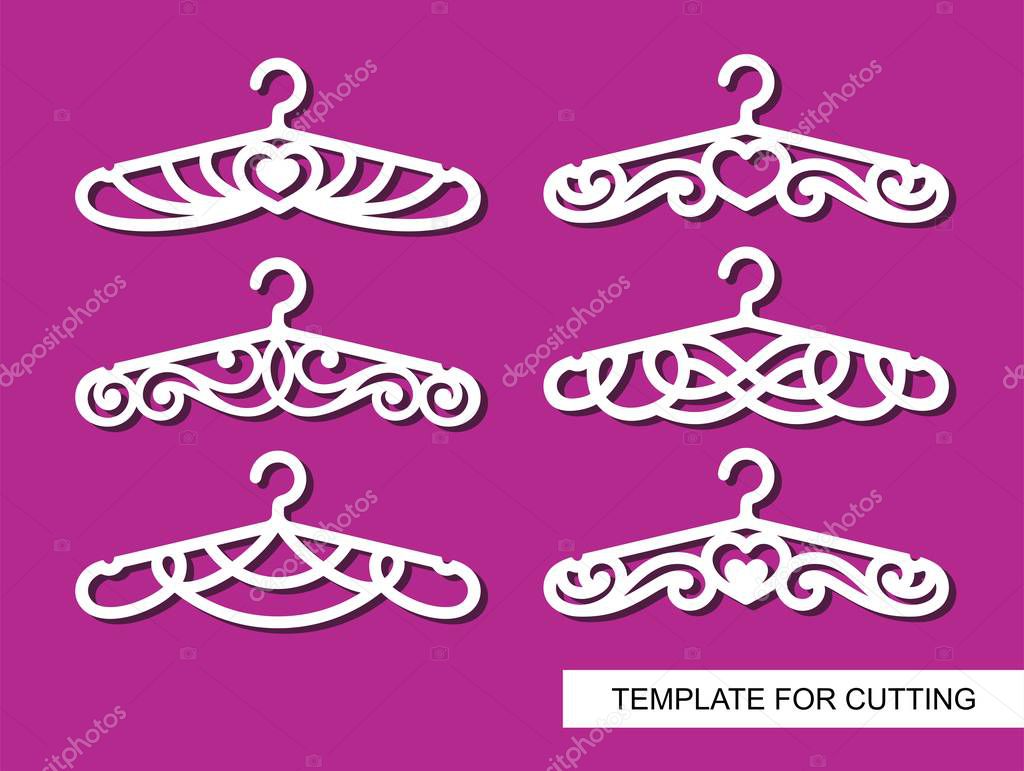 Set of decorative clothes hangers for atelier, wedding salon, boutique or store. White objects on pink background. Template for laser cutting, wood carving, paper cut and printing. Vector illustration