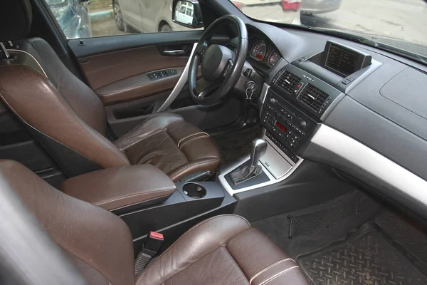 Driver\'s seat in the car with a brown interior