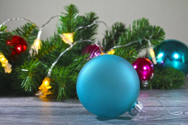 Christmas toy simple blue ball on the background of the Christmas tree