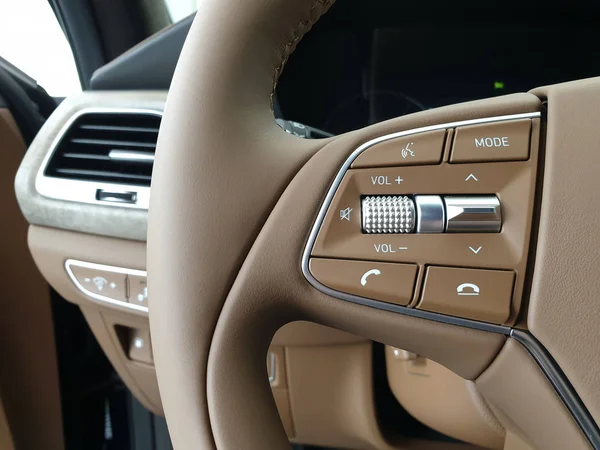 Media control buttons on the steering wheel of a car. Hands-free