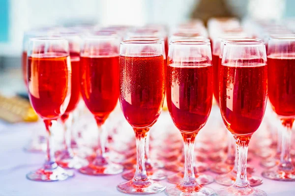 soft focus. Glasses with Rose wine for guests at the buffet table before the wedding ceremony. A lot of glasses with red champagne on the banquet table. Festive table setting. Wine list for the holiday.