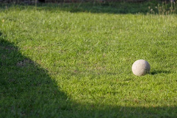Old football on green garden at thailand — Stock Photo, Image