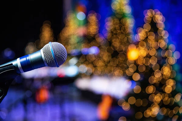 Microphone on stage with twinkle lights in background