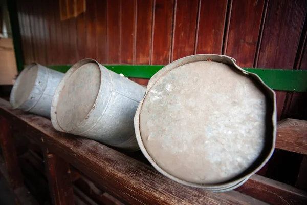 Traditional farming tools for transport of report or water. Vintage milk cans