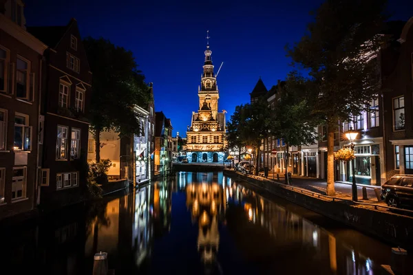 Details of streets, houses, alleys and canals in the old town of Alkmaar in North Holland. Beautifully illuminated city with monuments and locations, photographed in the evening and the night.