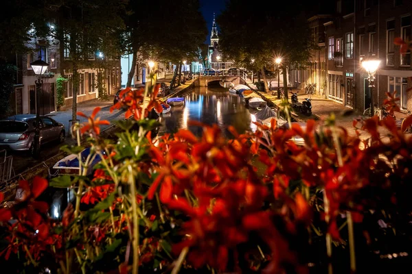 Details of streets, houses, alleys and canals in the old town of Alkmaar in North Holland. Beautifully illuminated city with monuments and locations, photographed in the evening and the night.