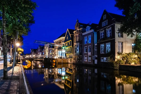 Details of streets, houses, alleys and canals in the old town of Alkmaar in North Holland. Beautifully illuminated city with monuments and locations, photographed in the evening and the night.