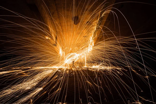 Burning Steel Wool spinning. Showers of glowing sparks from spin