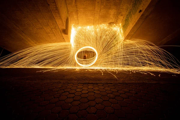 Burning Steel Wool spinning. Showers of glowing sparks from spin