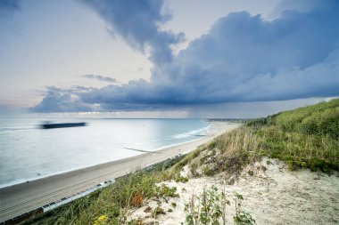 Long exposure view along dunes between Zoutelande and Vlissingen, The Netherlands. clipart