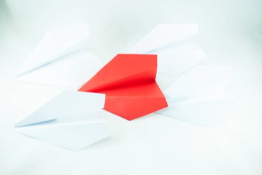 Kırmızı kağıt uçak izole beyaz bir arka plan üzerinde beyaz olanlar arasında. Konsept (fikir) havayolları, özgürlük, liderlik, başarı ve bireycilik.