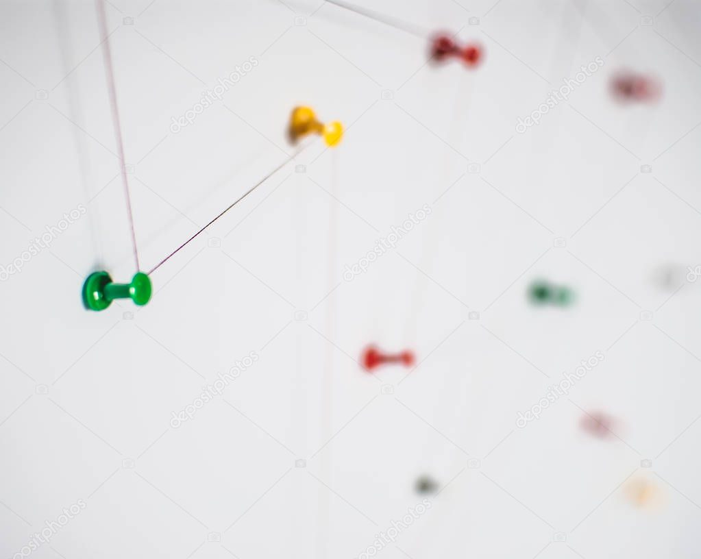Background. Abstract concept (idea) of network, social media, internet, teamwork,  communication abstract. Colorful push pins linked together by red thread. Isolated. Entities connected.