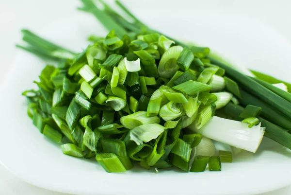 Fresh juicy green onion sliced on the white background. Isolated.