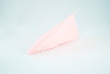 İzole beyaz bir arka plan üzerinde pembe (şeftali) kağıt uçak. Konsept (fikir) havayolları, özgürlük, liderlik, başarı ve yaratıcılık. Yakın çekim