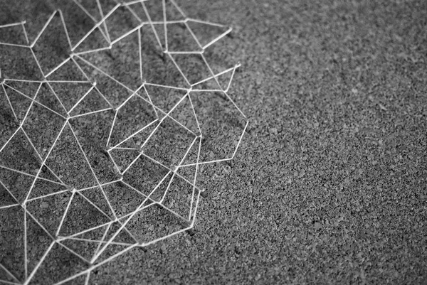 Background. Abstract concept (idea) of network, social media, internet, teamwork,  communication abstract. Nails linked together by threads. Isolated. Entities connected.