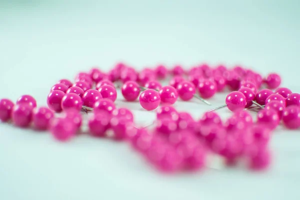 Pink thumb tacks isolated on a white background