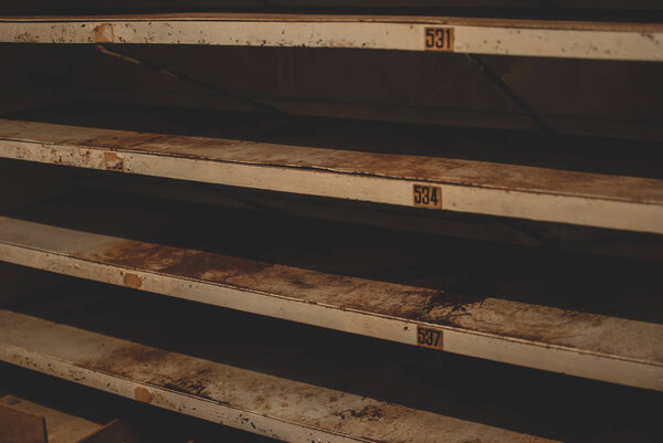 Empty metal shelves covered with rust in the storage