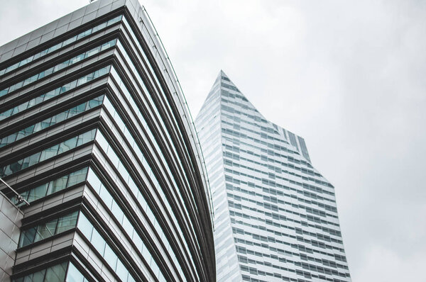 Cityscape of business buildings in Warsaw, Poland. High skyscrapers with numerous windows. Cloudy afrernoon