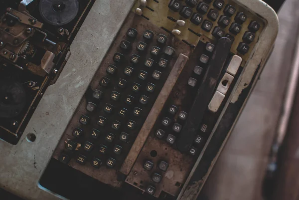 Dusty old-fashioned calculating machine in the storage. Top view