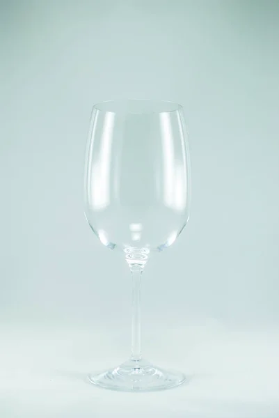 Closeup of a transparent empty wine glass. Isolated on the white background.