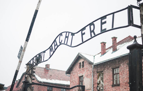 Oswiecim, Poland - February 16, 2018: The famous arch of the concentration camp Auschwitz. Inscription: Arbeit macht frei.