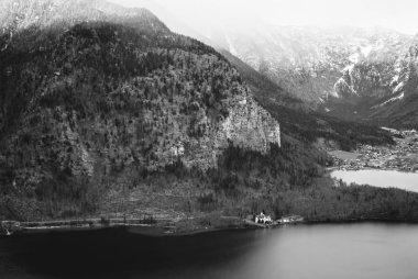 Hallstatt gökyüzünde nefes kesen siyah beyaz manzara manzara. Karanlık Dağ Gölü ve zirveleri karla kaplı. Avusturya Alpleri'nde.