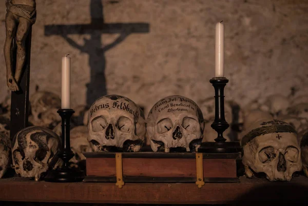 ハルシュタットの教区教会に頭蓋骨を装飾されています ビンテージの燭台や地下室の壁に十字架の影 — ストック写真