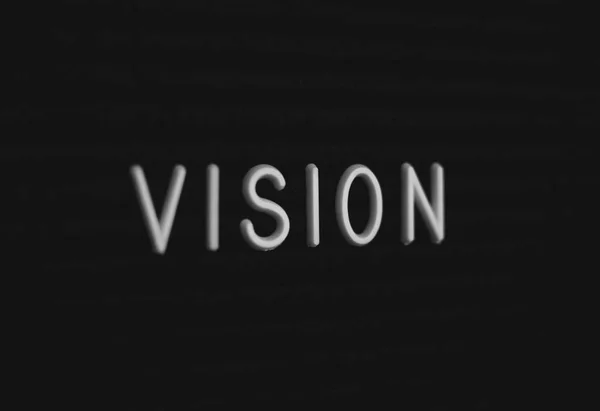 Word vision written on the letter board. White letters on the black background