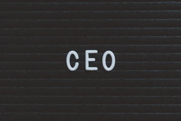 Word CEO written on the letter board. White letters on the black background. Business concept