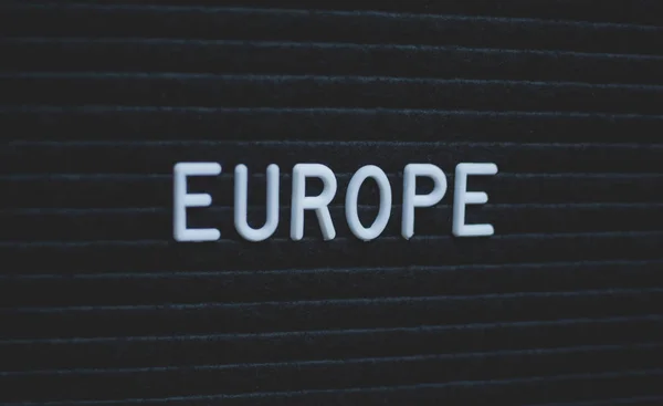 Word europe written on the letter board. White letters on the black background. Business concept