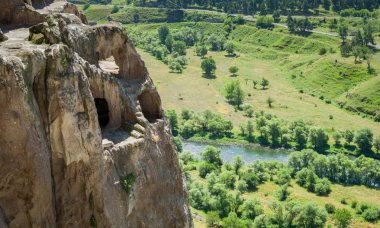 Mağaralar Vardzia Manastırı, Georgia. Kayalık yeşil dağlar ve tepeler kapsayan çimen.