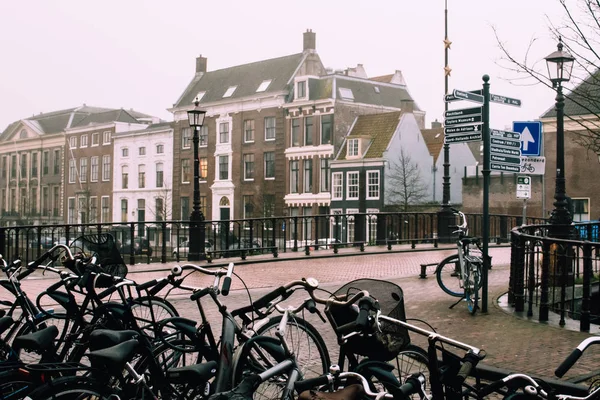 Beautiful misty spring day in Harlem, Netherlands. Empty pedestrian bridge and bicycle parking lot. — Stock Photo, Image