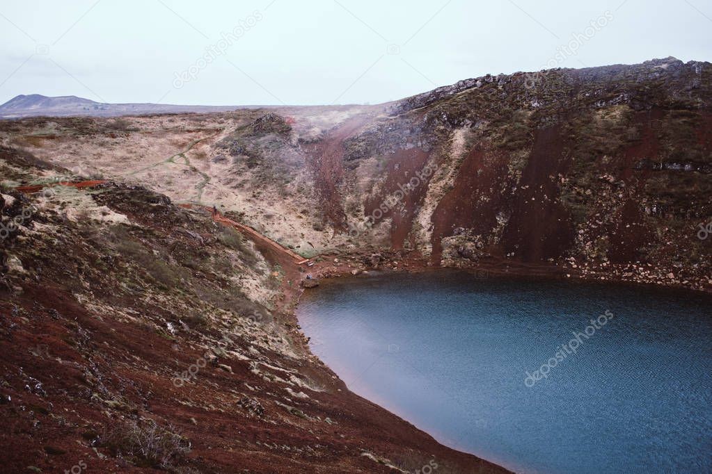 Kerid (Kerith) is a famous turquoise lake located in a volcanic creater and surrounded by magnificent hills of crimson red sand. Southern Iceland