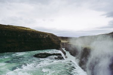 Gullfoss şelalesinin kenarı ve üzerinde uçan su sıçrayışları