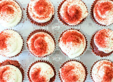 Kırmızı kadife keklerin üst görüntüsü bir kutuda düzenlenmiş.