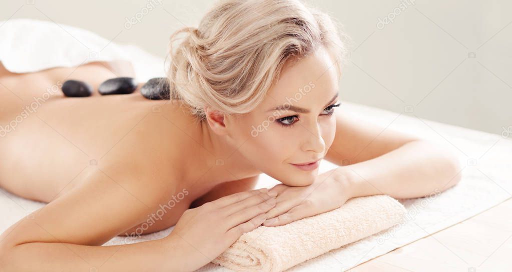 Beautiful and healthy blond woman getting spa therapy and massaging treatments. Recreation and healthcare concept.