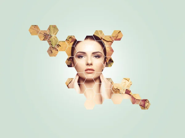 Beautiful face of young, natural and healthy girl over fallen leaves. Healthcare, spa, makeup and face lifting concept with honeycomb grid over autumn background.