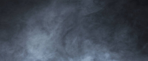 Abstract smoke texture over black background. Fog in the darkness. Halloween concept.