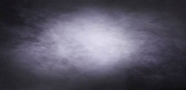 Abstract smoke texture over black background. Fog in the darkness. Halloween concept.