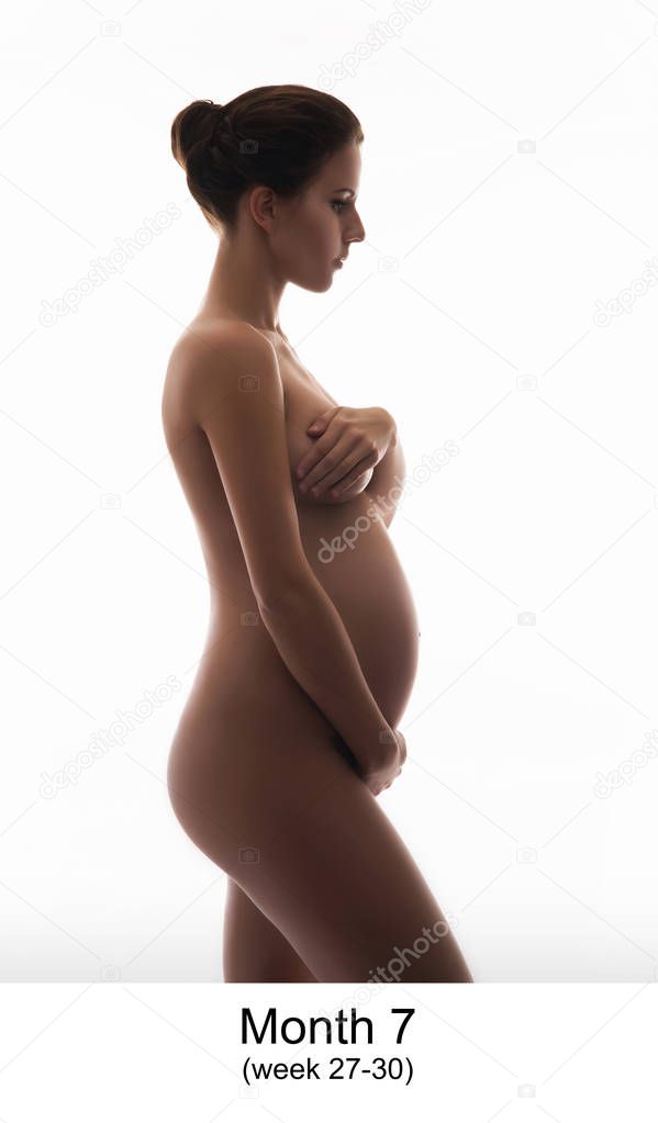 Beautiful pregnant woman expecting baby isolated on white. Month 7, week 27-30.